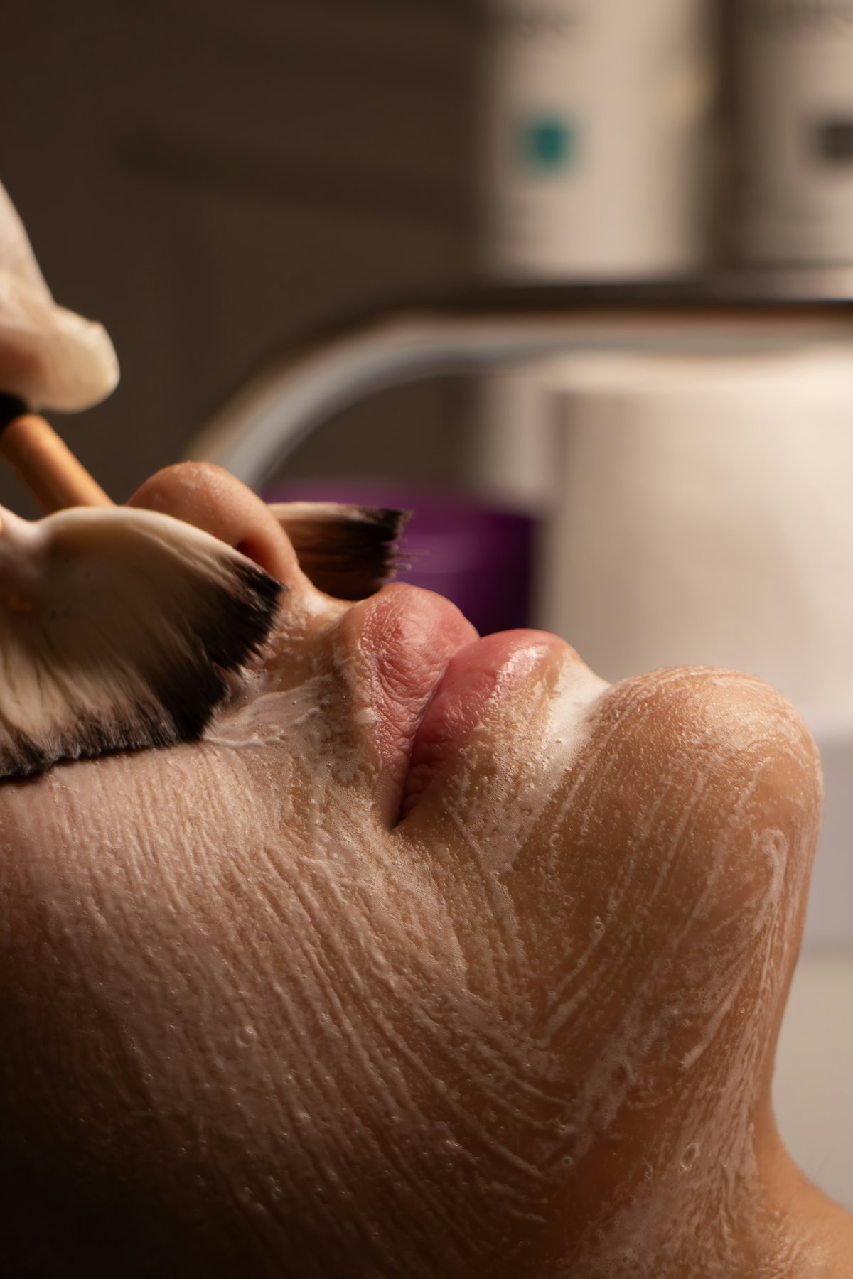 Chemical peel solution being applied to the face with a brush